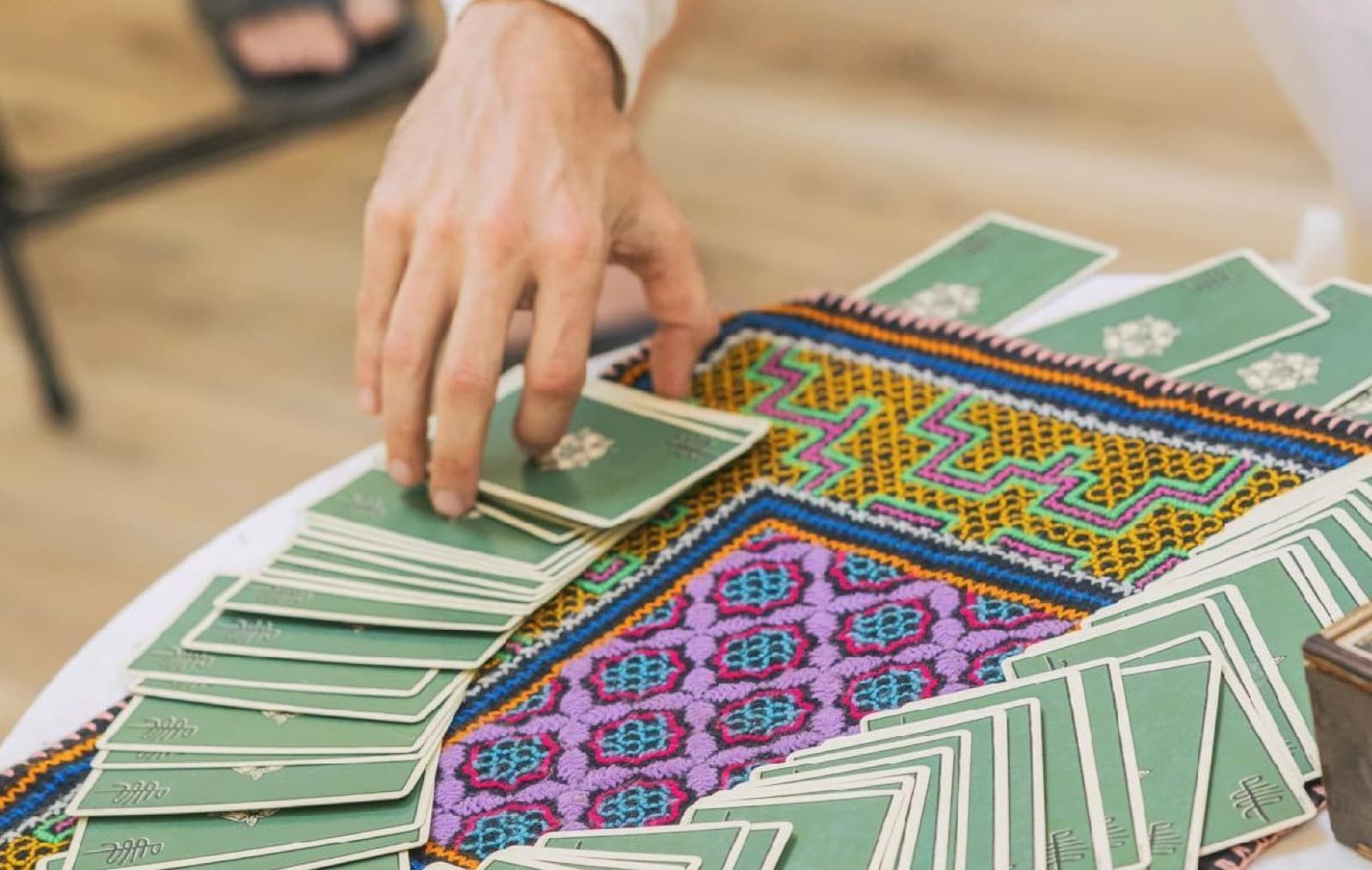 A reading in progress, cards laid out across the table